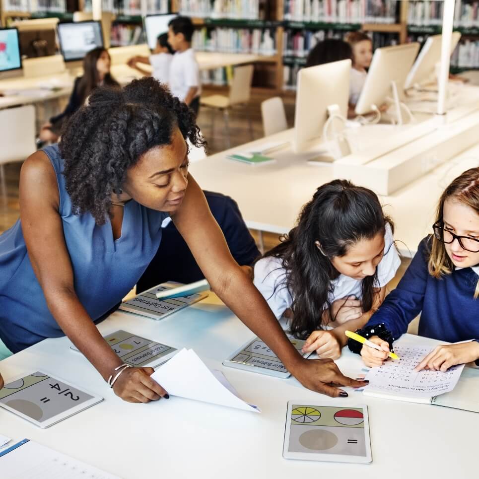 Image showing a teacher working with her class