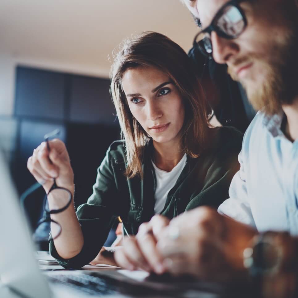 Image showing a team working on a laptop together