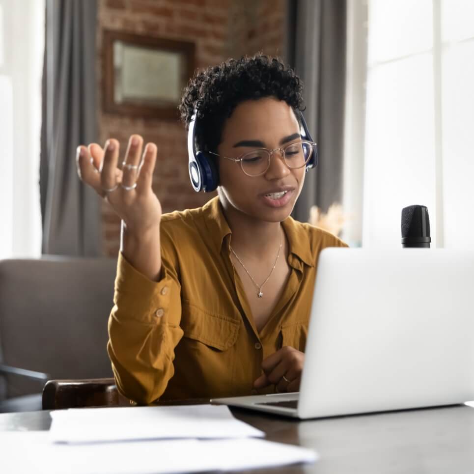 Image showing a woman wearing a headset in front of a laptop