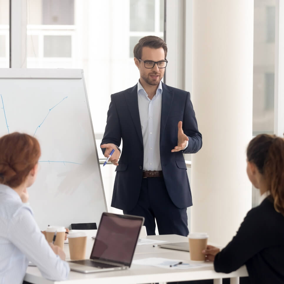 Image showing a man presenting to team members