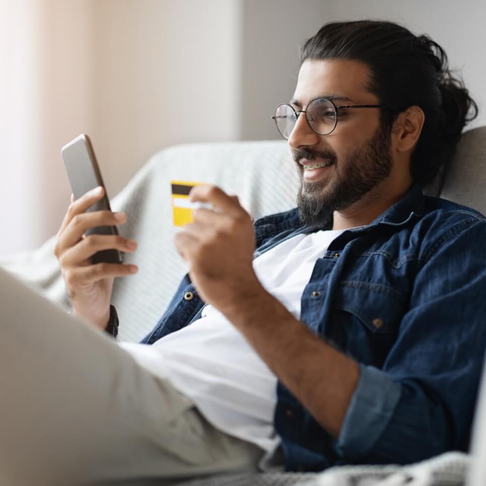 Image showing a man with his payment card and mobile phone