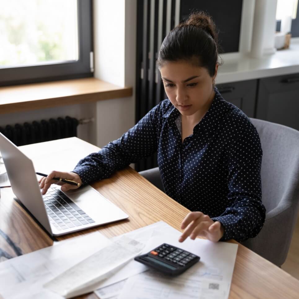 Image showing a woman using a calculator